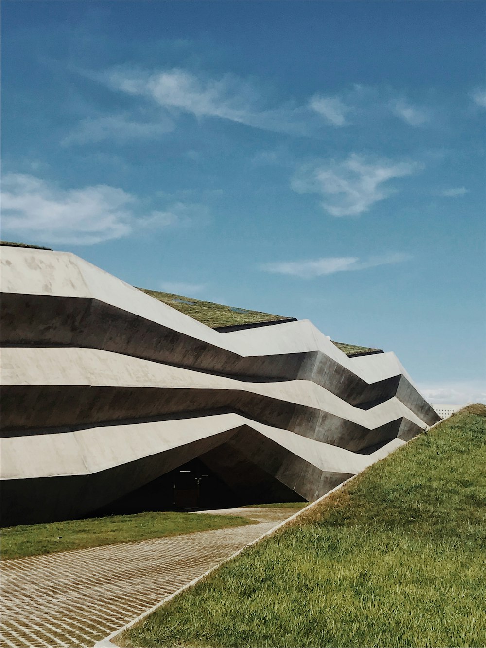 green grass field and brown concrete building