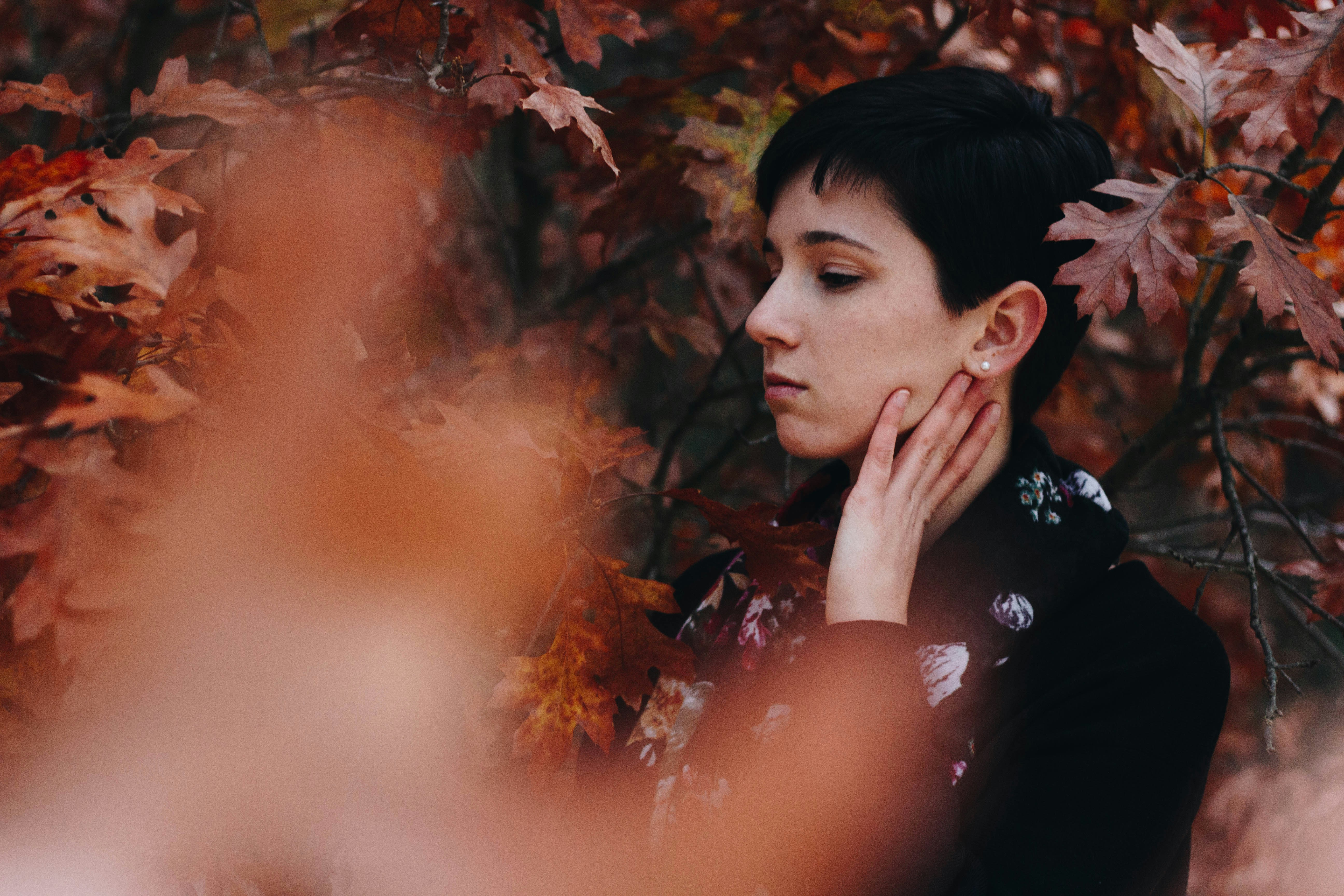 woman in black long-sleeved top facing sideways