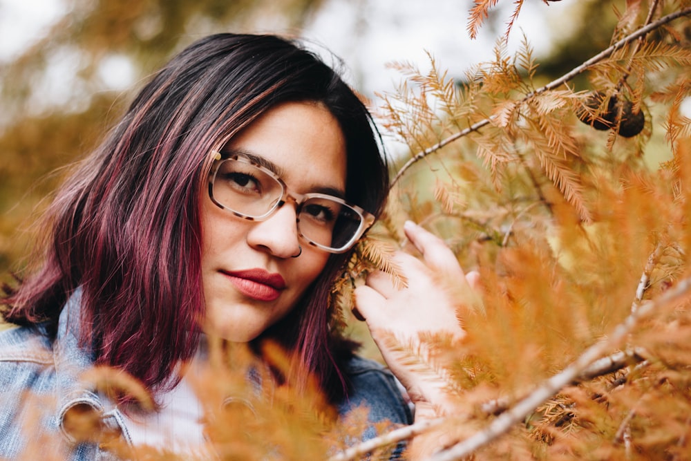 shallow focus photo of woman wearing eyeglasses with brown frames