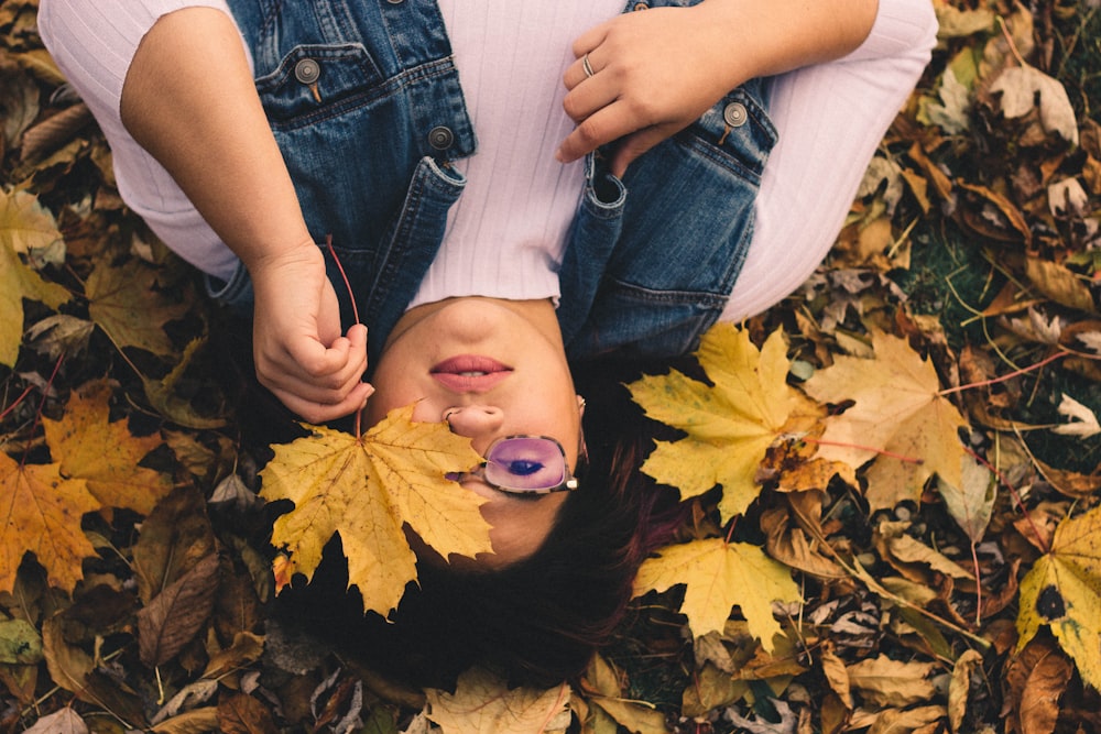 woman lying on maple leaf lot