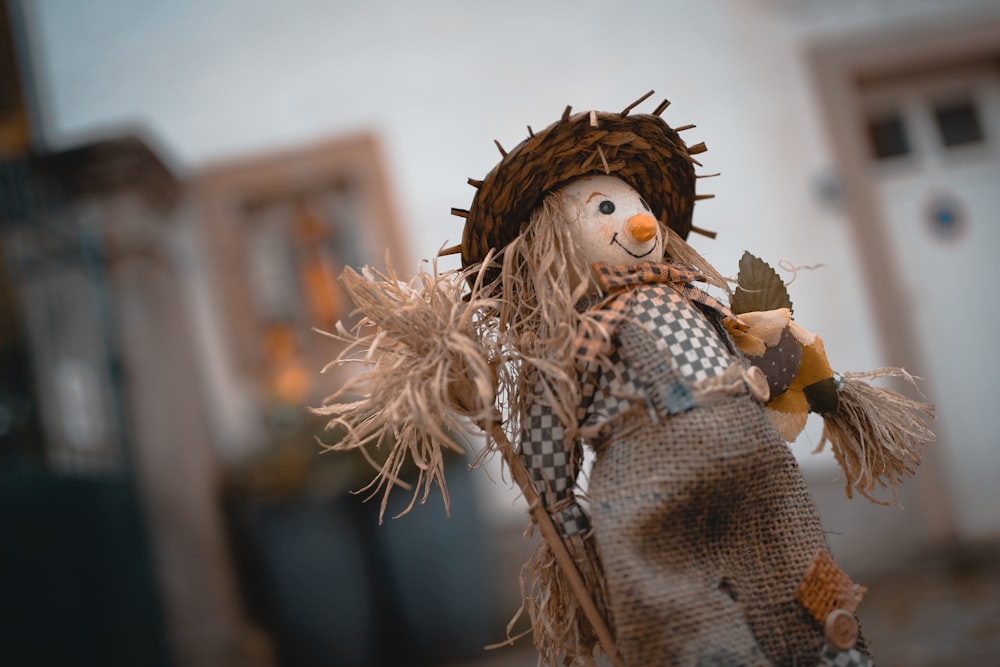 selective focus photography of scarecrow