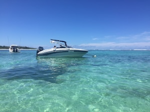 Speedboat cutting through crystal-clear turquoise water on a sunny day