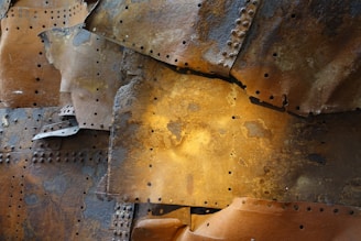 A close-up of stacked ship metal sheets with rust textures, ready for trade.