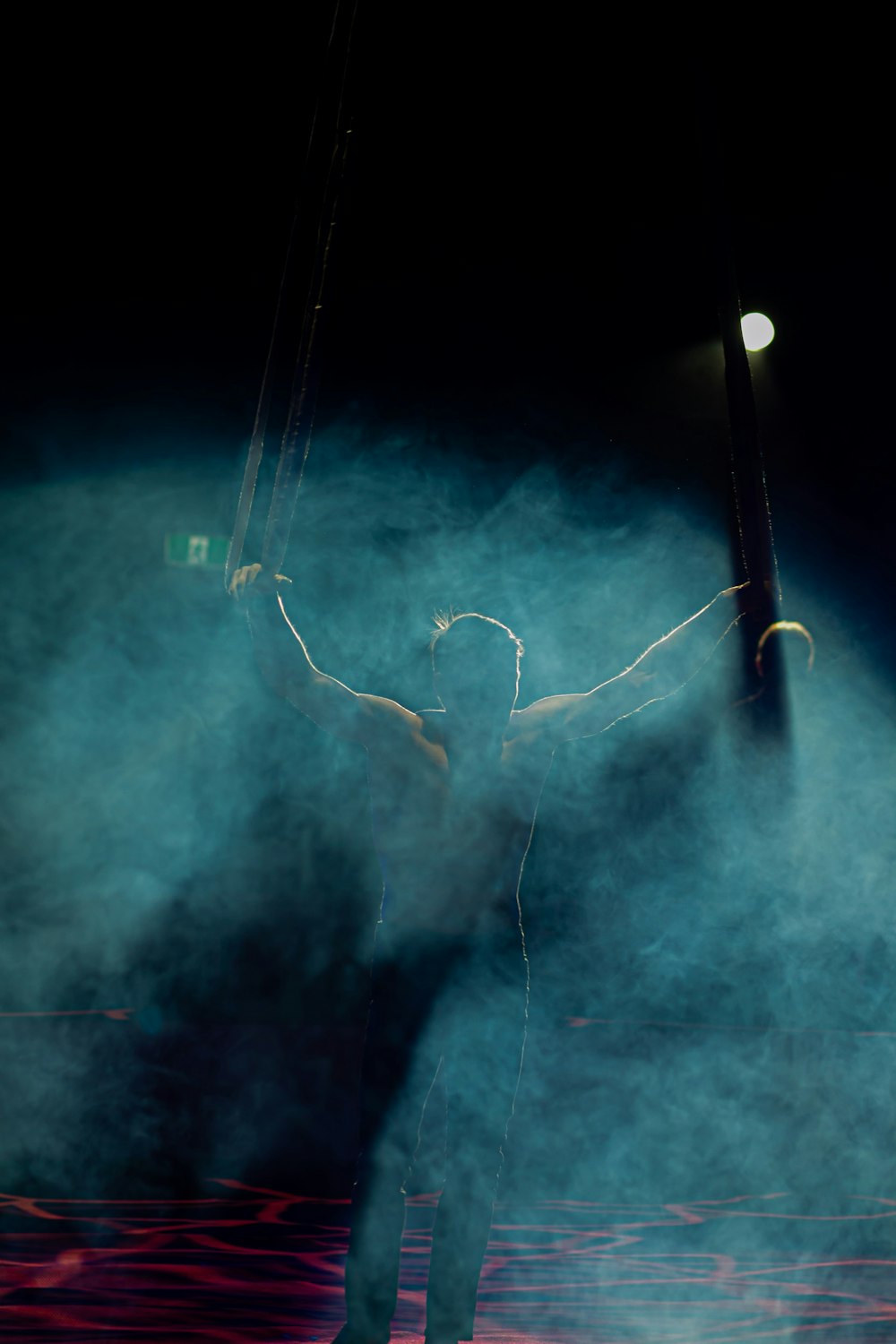 man raising his hands performing