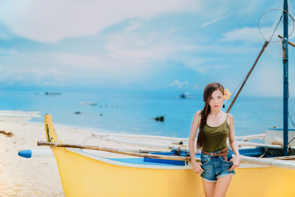 woman standing in front of yellow boat