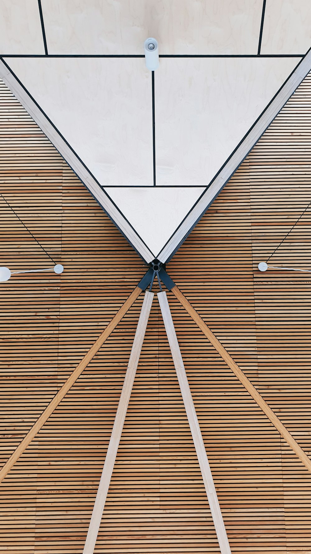 a close up of a wooden floor with a skylight