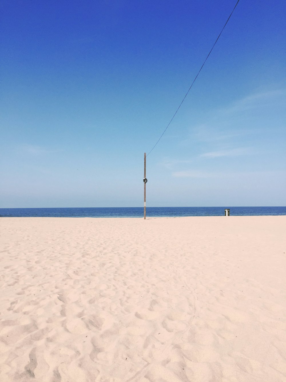 gray pole on seashore during daytime