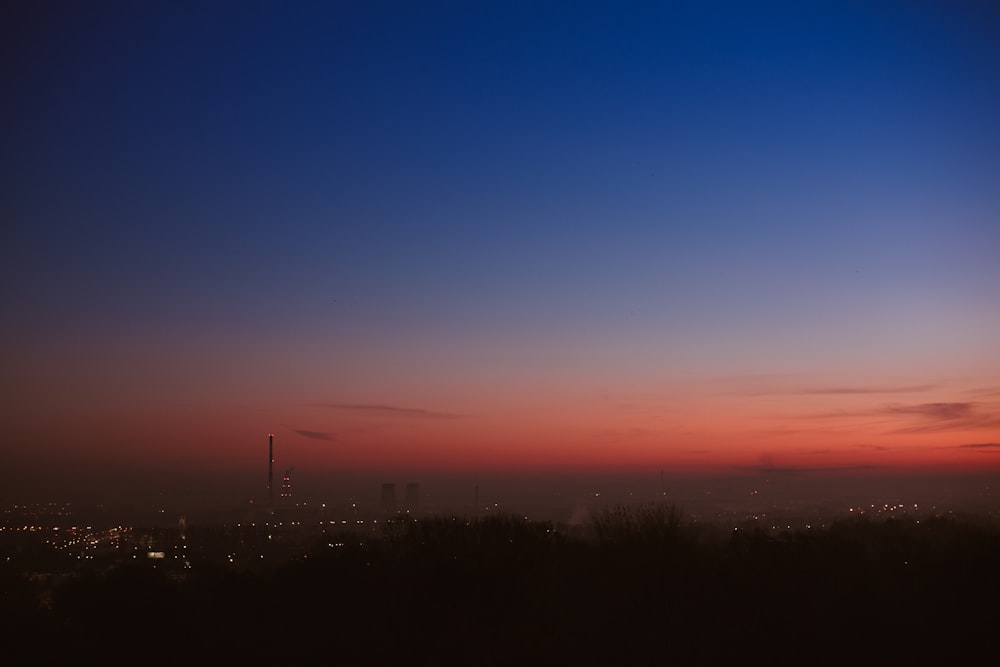 a view of a city at night from a hill