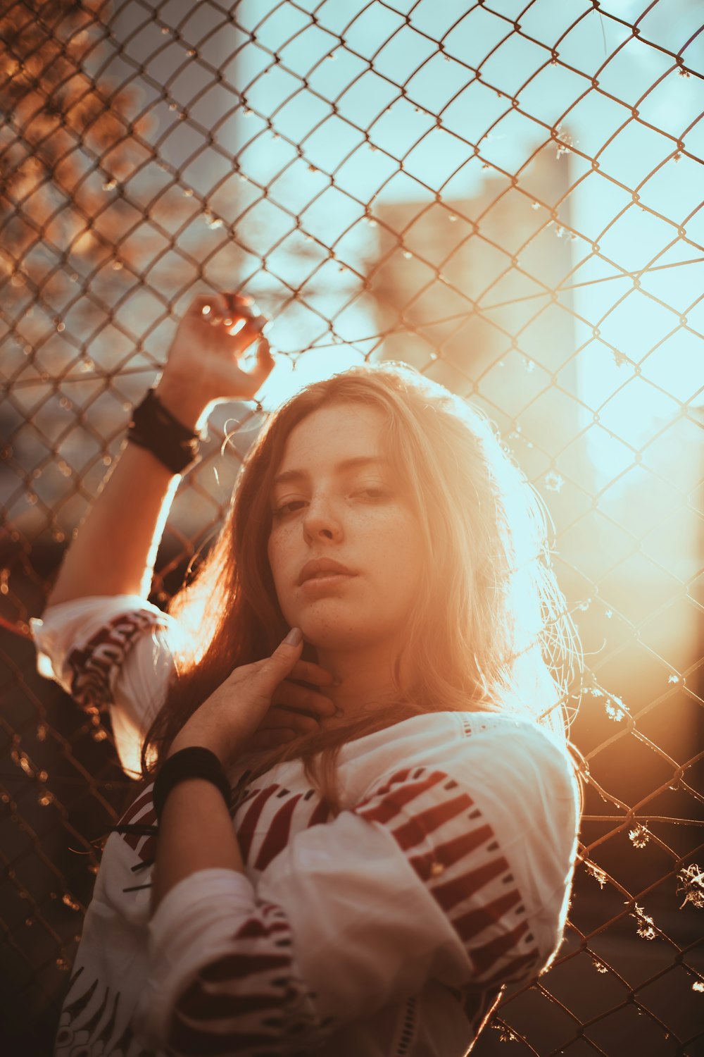 woman leaning on fence during daytime