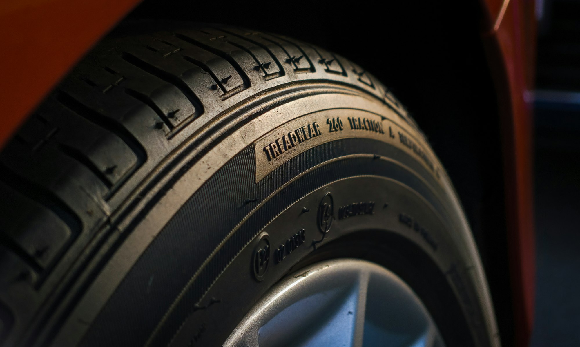 High End rubber tire closeup during sunset, focused on the typography. 