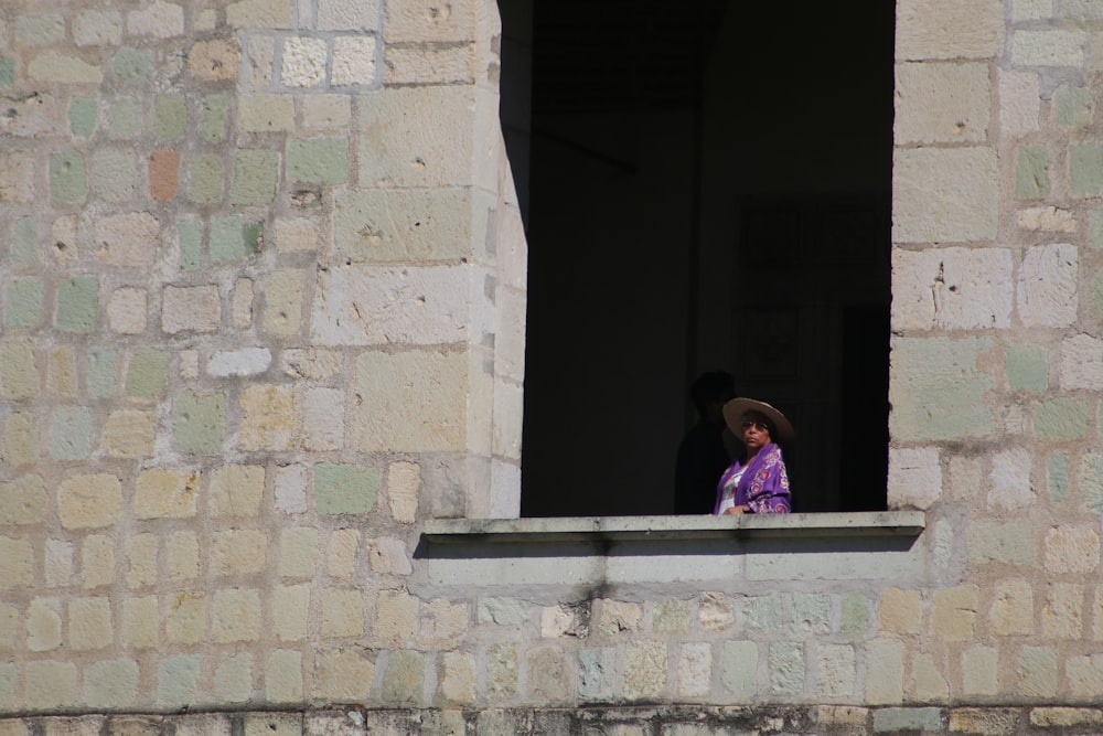 woman standing beside window