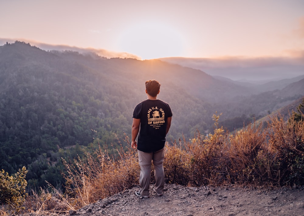 man stands at the edge of the cliff