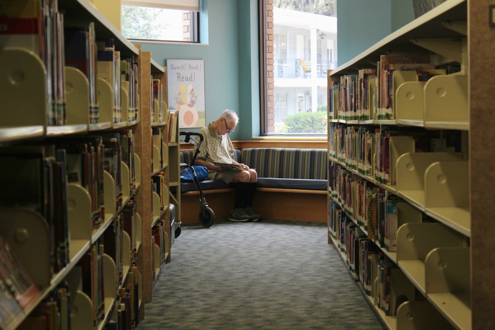 man reads book at the library