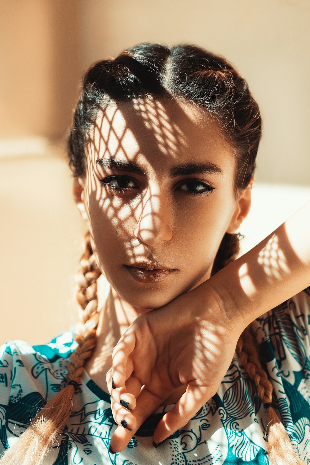 a woman with braids and a blue shirt