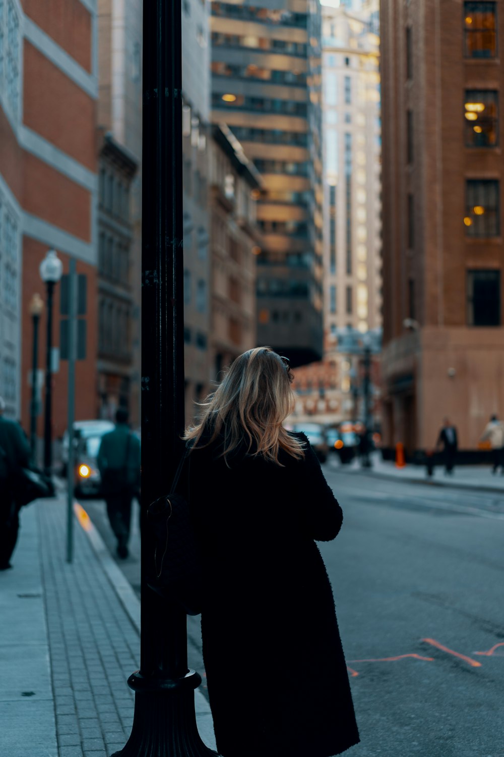 shallow focus photo of person in black trench coat