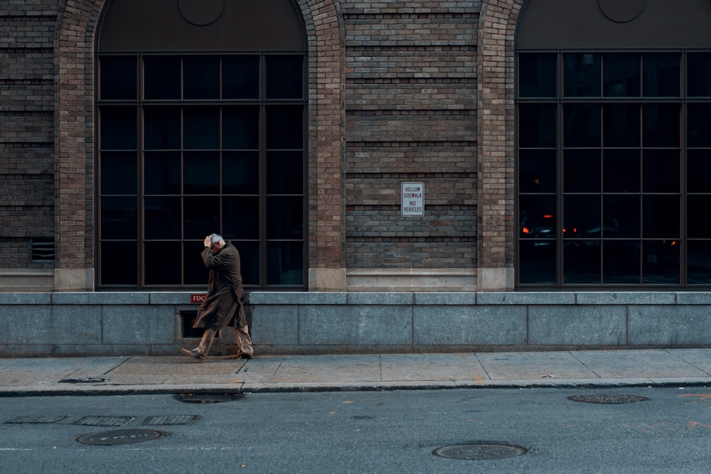 person standing beside building during daytime