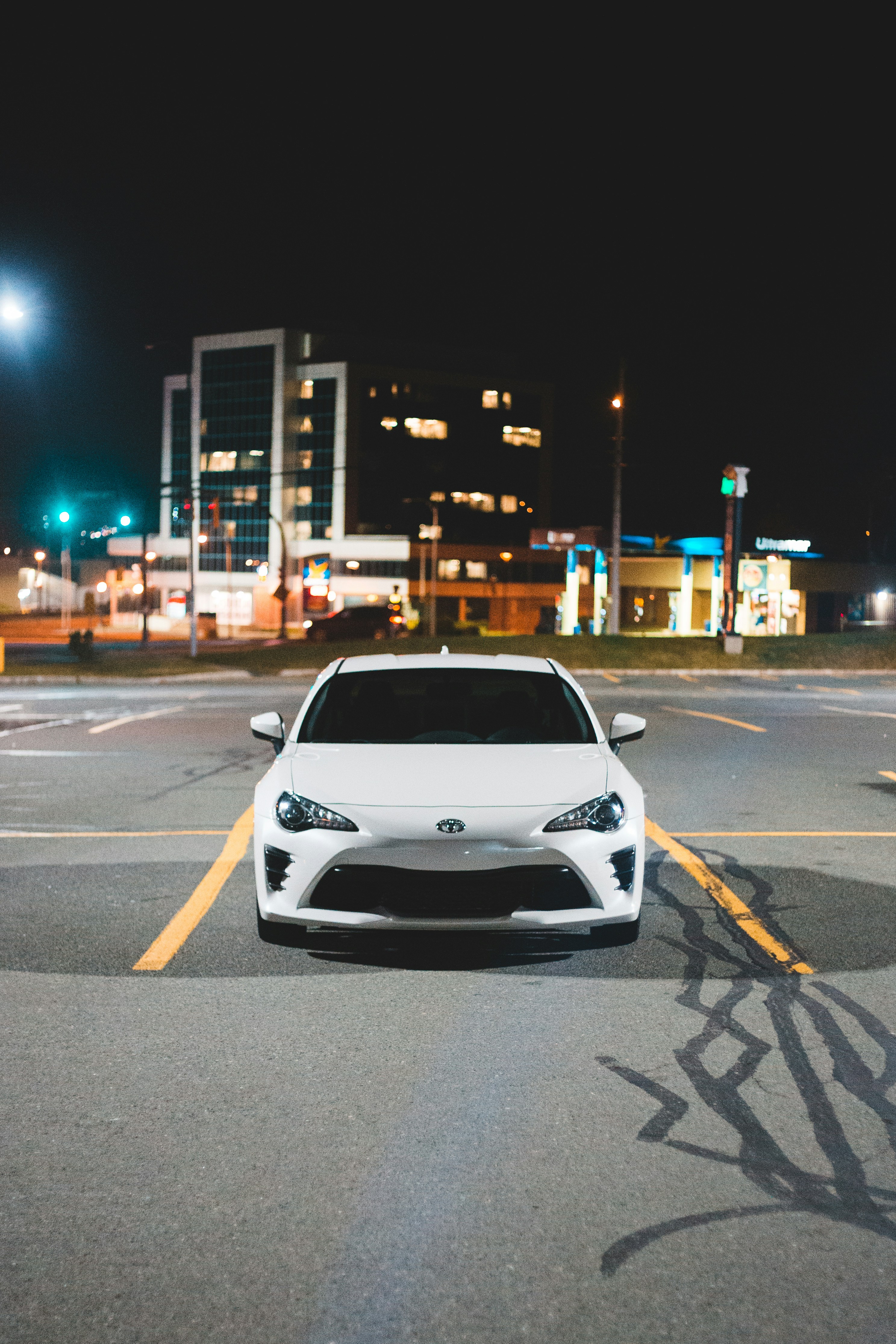 shallow focus photo of white car front-end