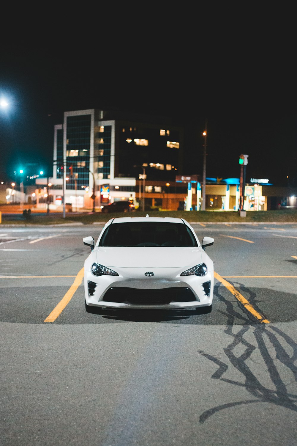 shallow focus photo of white car front-end