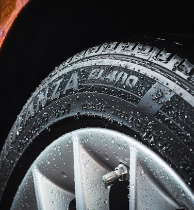 shallow focus photography of silver car wheel and car tire