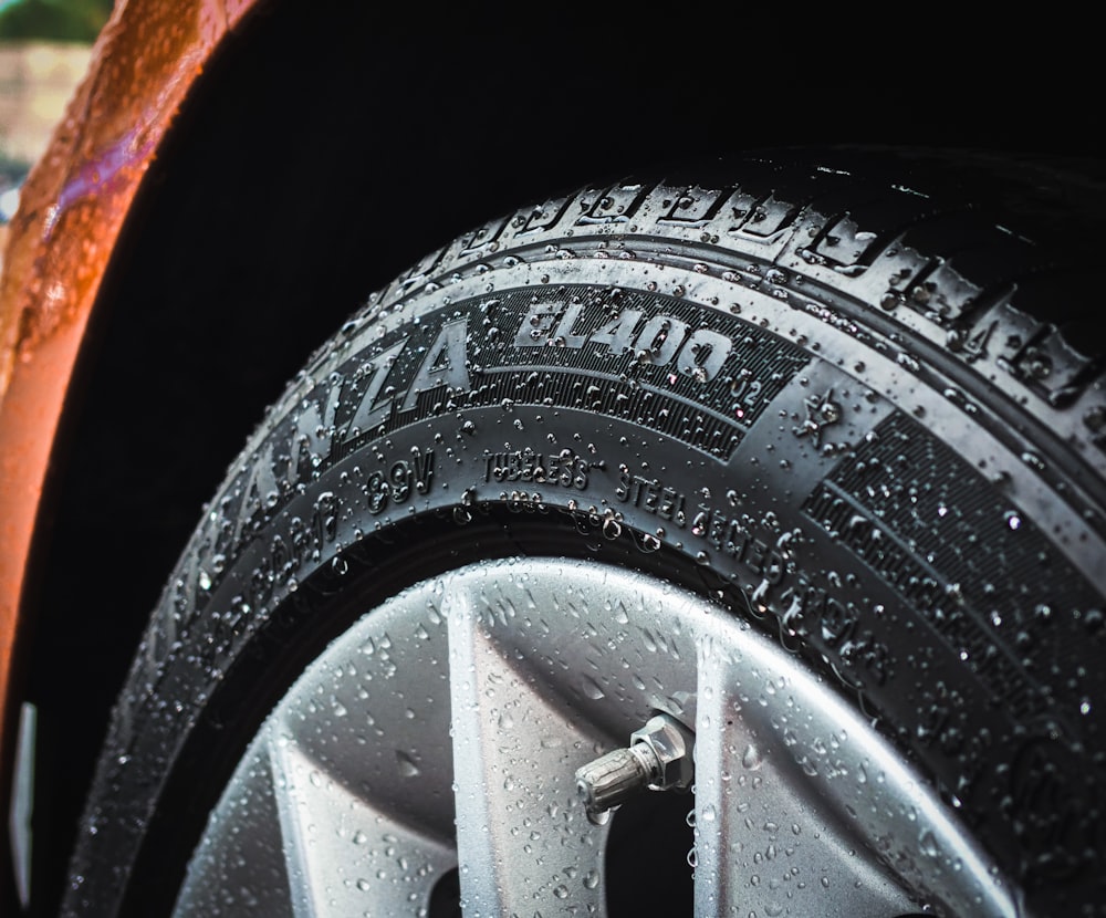 shallow focus photography of silver car wheel and car tire