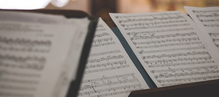 closeup photo of printer paper with musical notes