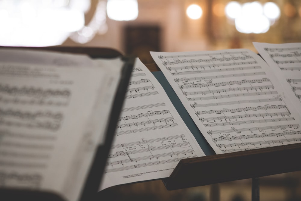 closeup photo of printer paper with musical notes