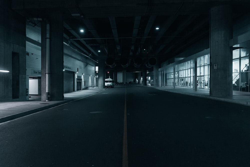 an empty street in a large building at night