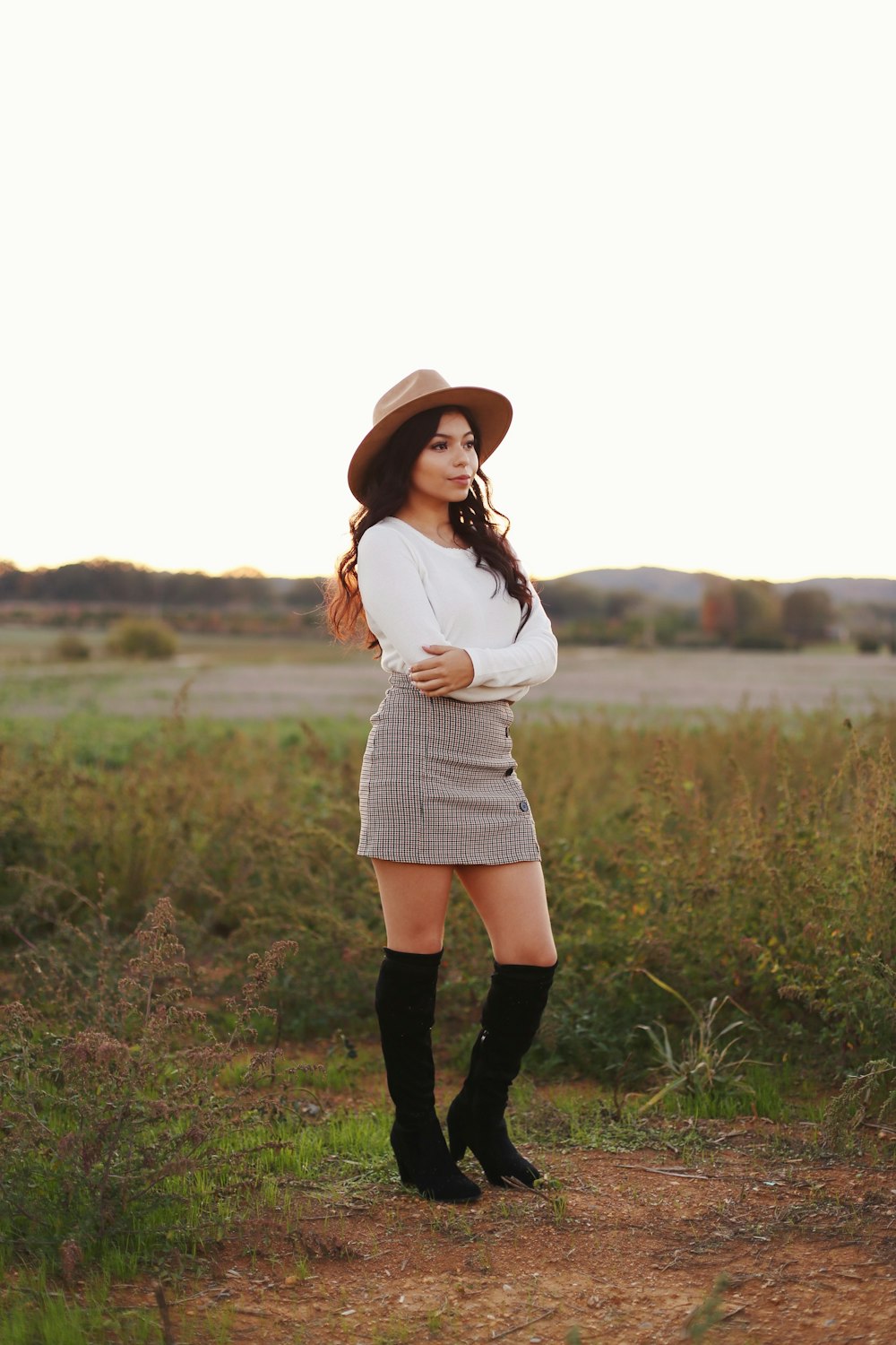 woman in white sweater and gray mini skirt