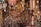 A variety of hanging ornaments and wind chimes are densely displayed, featuring intricate designs like trees, hearts, and flowers. These items are crafted from materials such as wood, metal, and glass, and are all suspended with price tags visible.