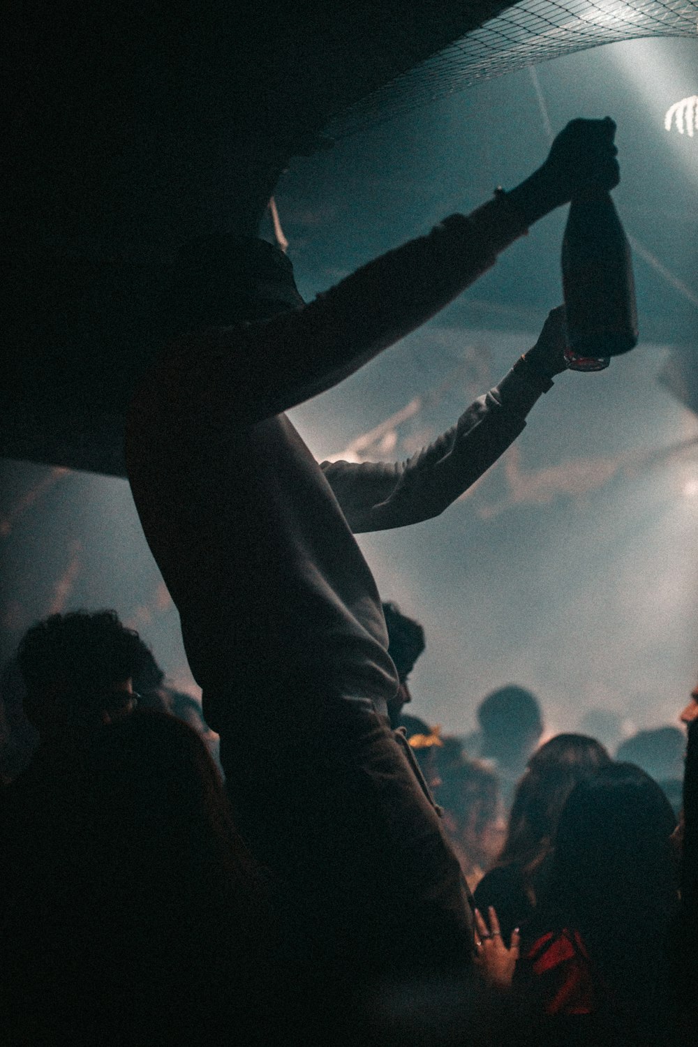 man holding glass bottle