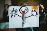 toddler holding drawing