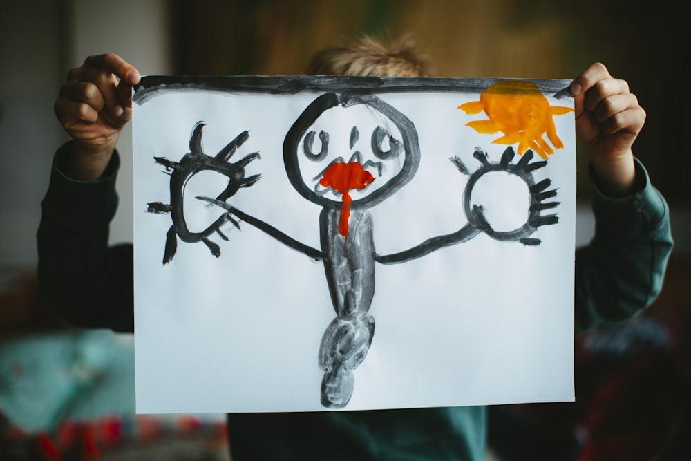 toddler holding drawing