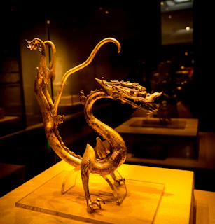 A golden dragon art piece glowing softly, symbolizing the energy of 369 and spiritual guidance.