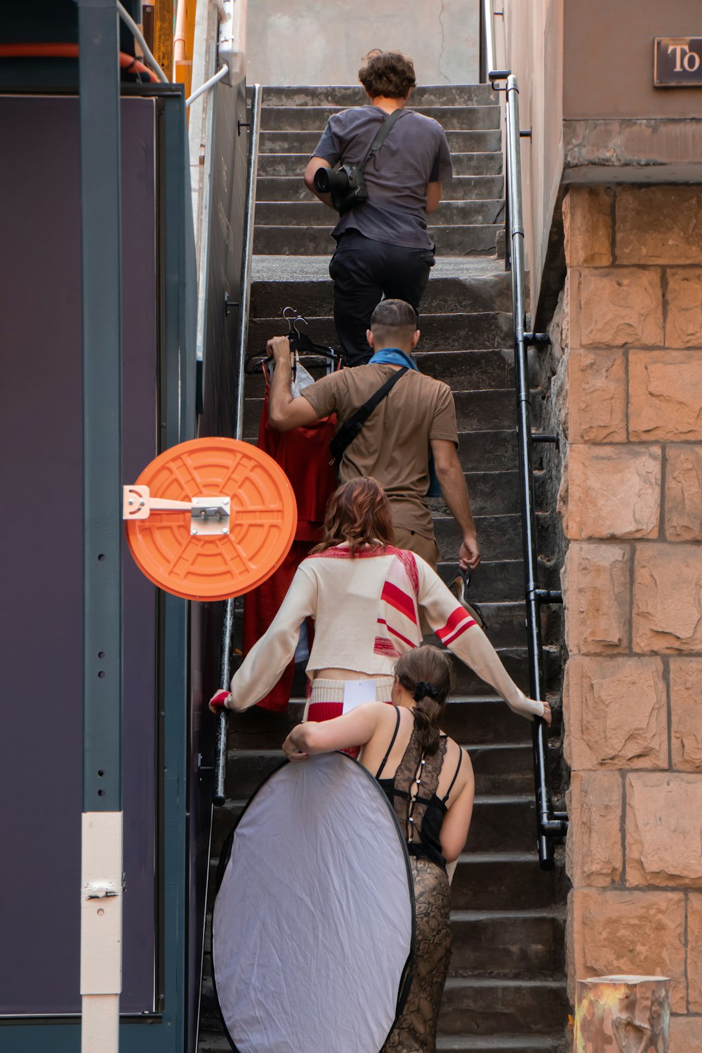 four people walking on stairs