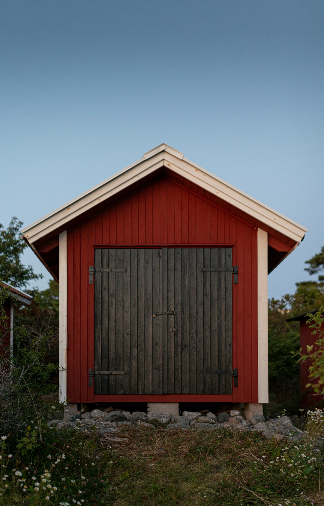  red wooden house near tree shed