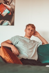 man sitting on sofa