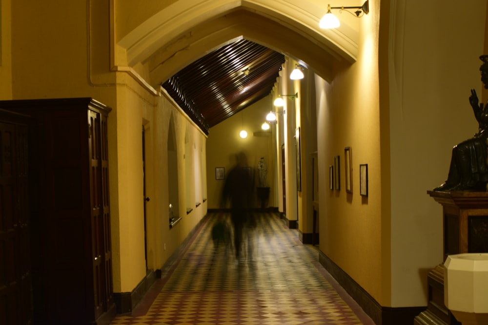 a person walking down a hallway in a building