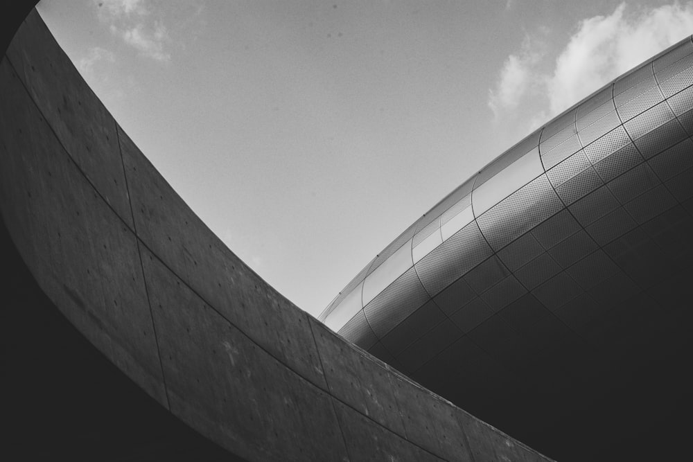 a black and white photo of a curved building