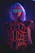 A vibrant cyberpunk rave scene with a person wearing glowing futuristic clothing from révolt.