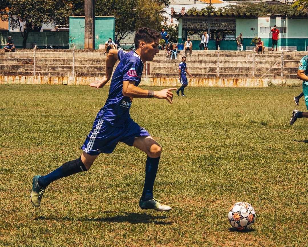 man playing soccer on field