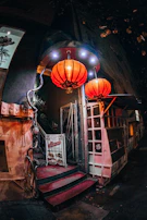 An inviting entrance of Musubiya Yurakucho with warm lanterns glowing in the evening.