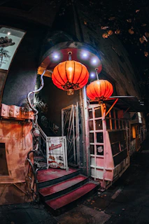 An inviting entrance of Musubiya Yurakucho with warm lanterns glowing in the evening.