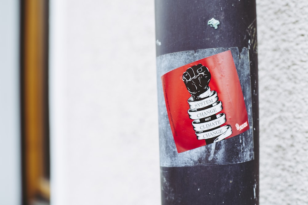 black and white fist-printed poster on a metal post