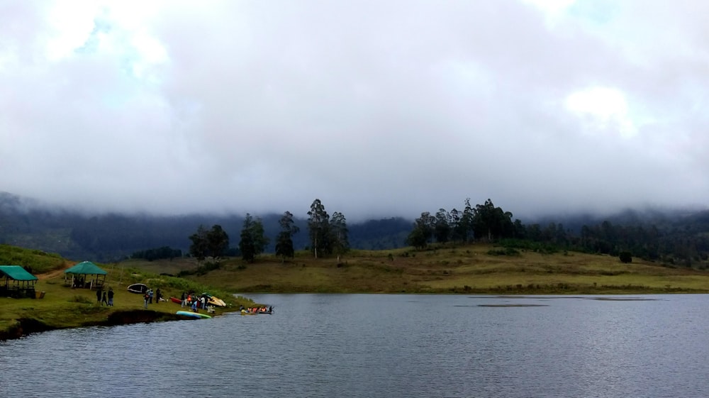 people camping beside body of water during daytime