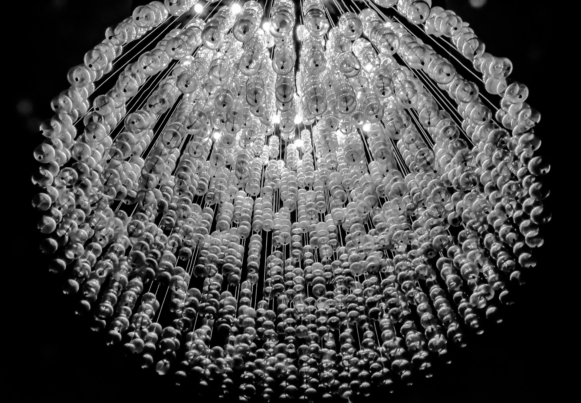 a chandelier hanging from the ceiling in a dark room