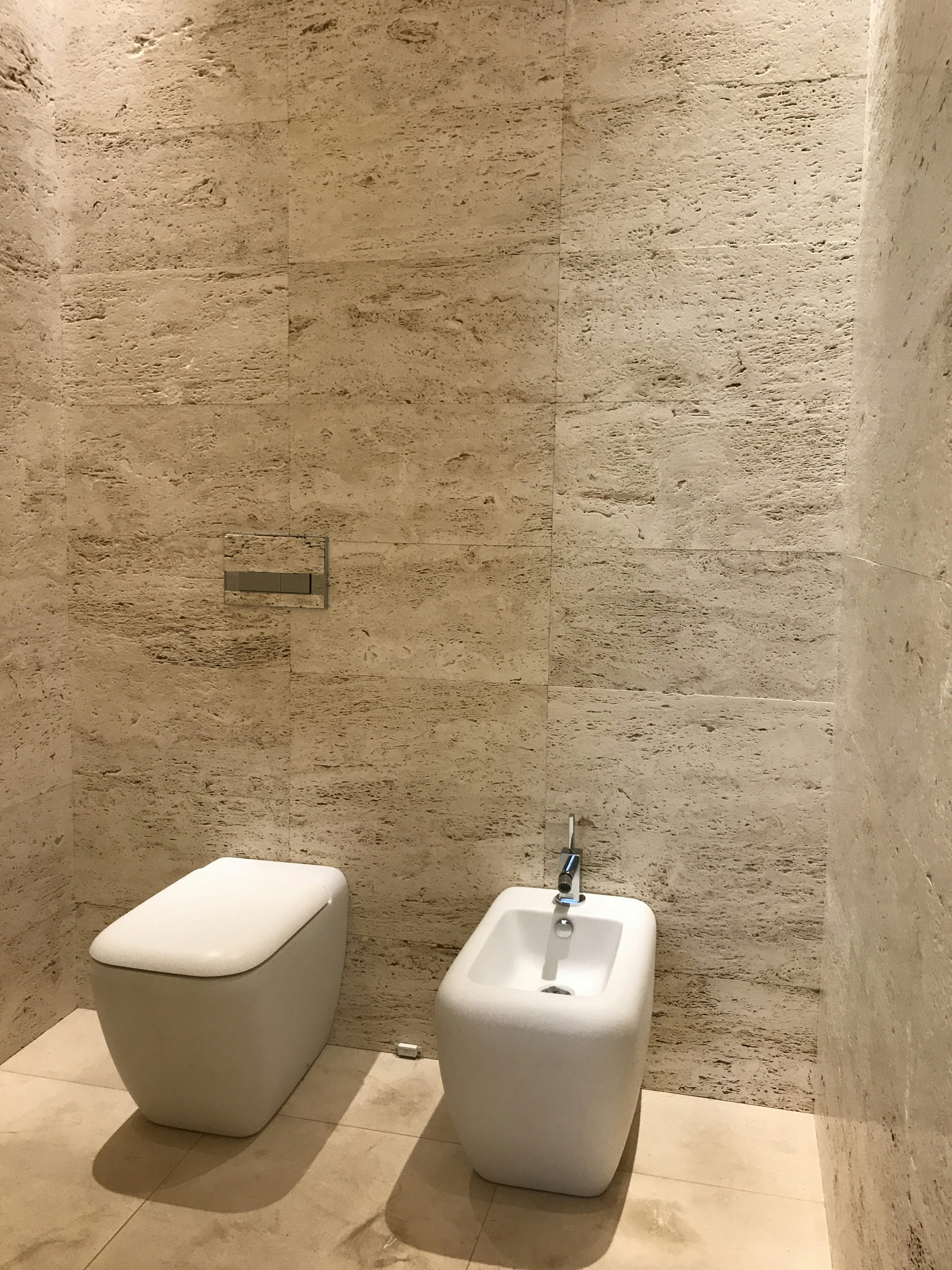 A modern bathroom with an integrated bidet and dryer toilet seat