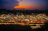 A vibrant sunset over a bustling market in Bandung.
