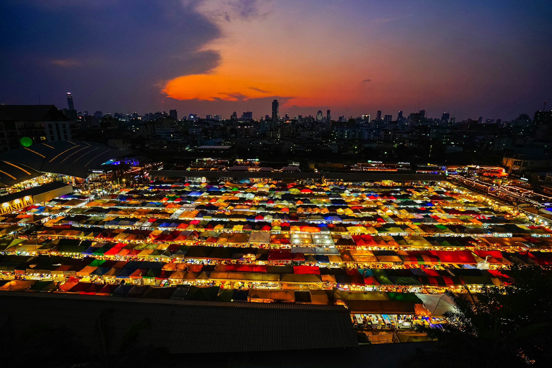 A photographer capturing the golden hour light over a colorful Santiago street, with vibrant murals and lively market stalls.