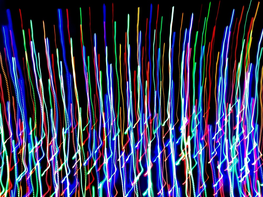 a very long exposure of colorful lights on a black background