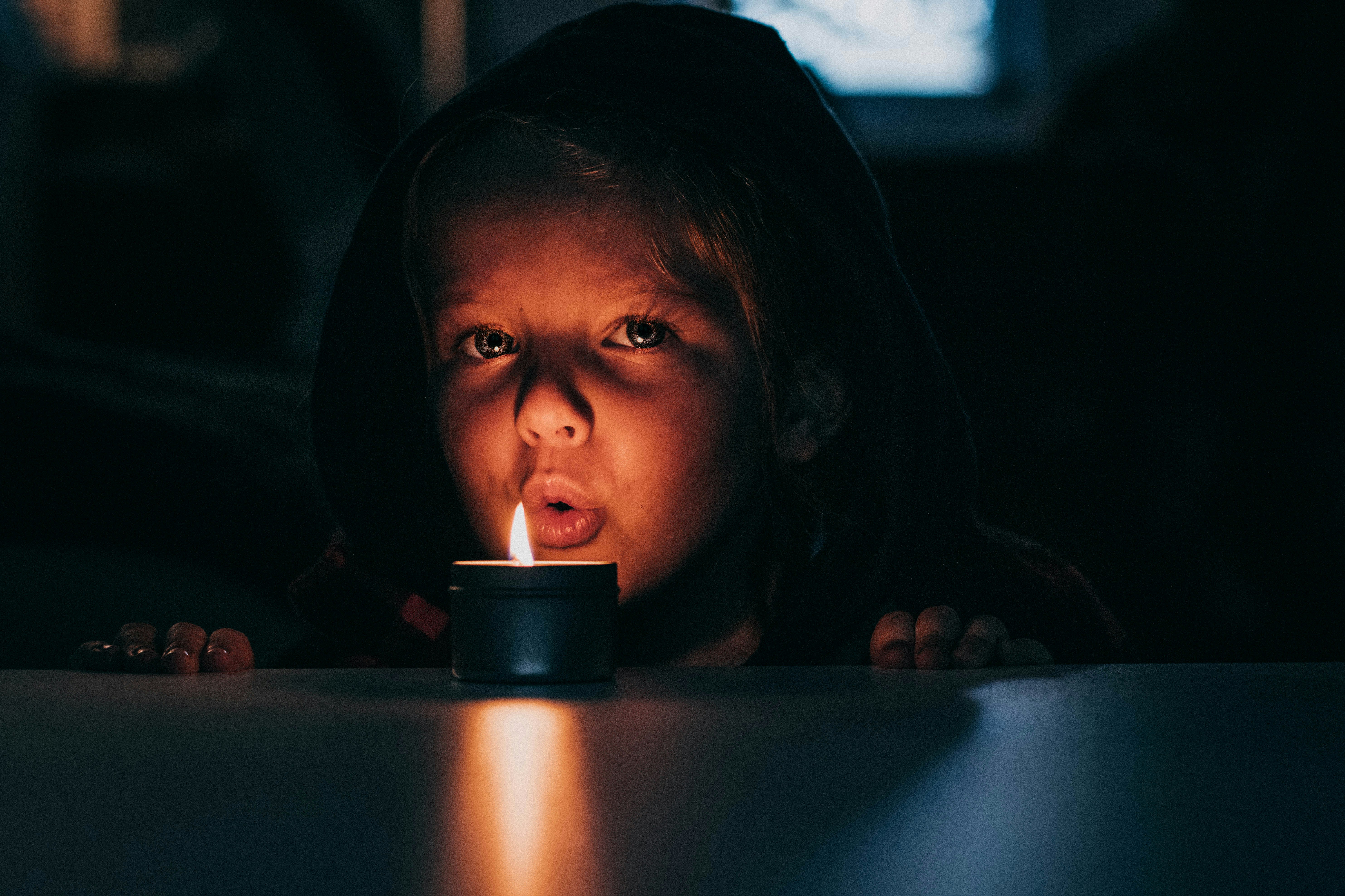 girl blowing the candle